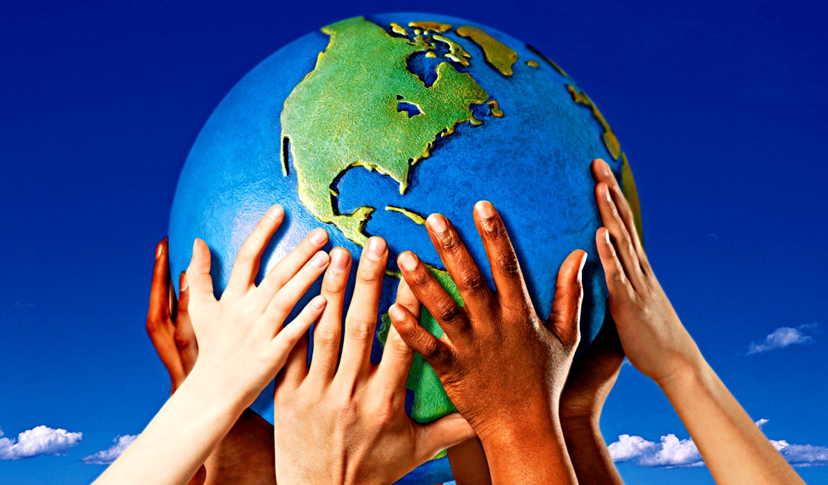 Children place their hands on a globe to save planet earth